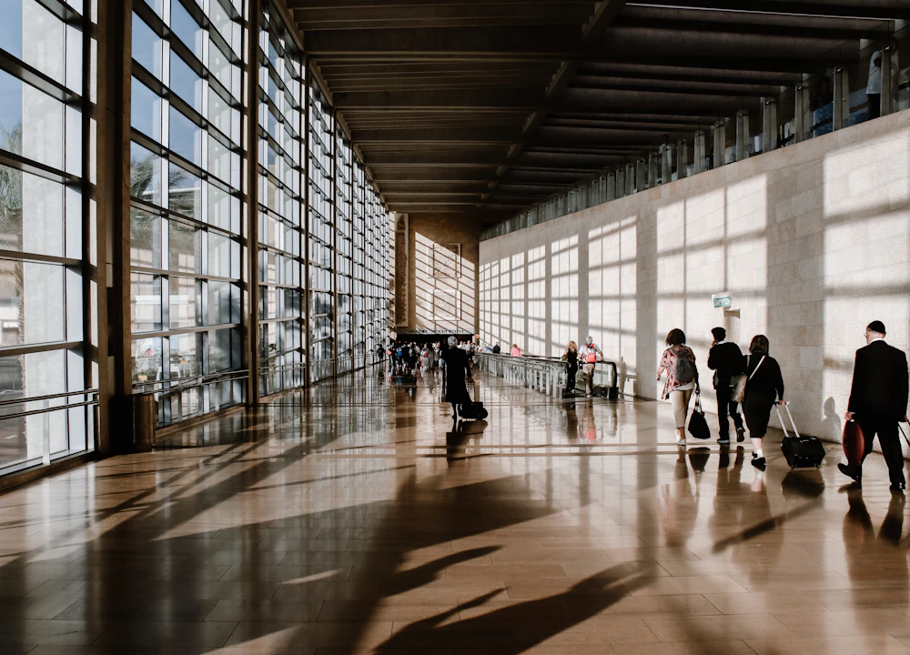 Travellers walking through a bright airport terminal
