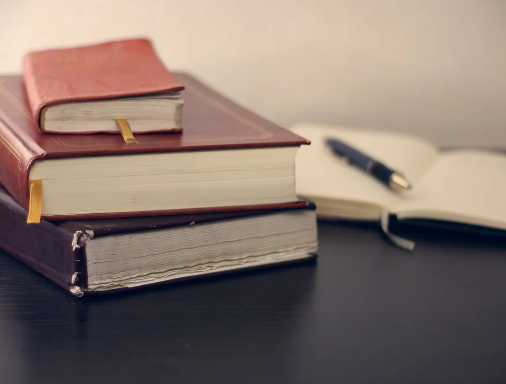 Law books and an open notebook on a desk